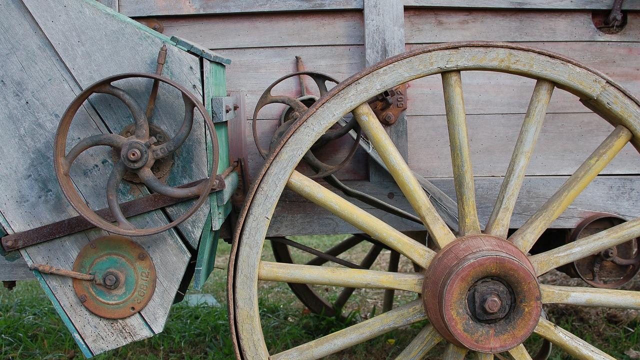 wagon wheel leaning against a wagon