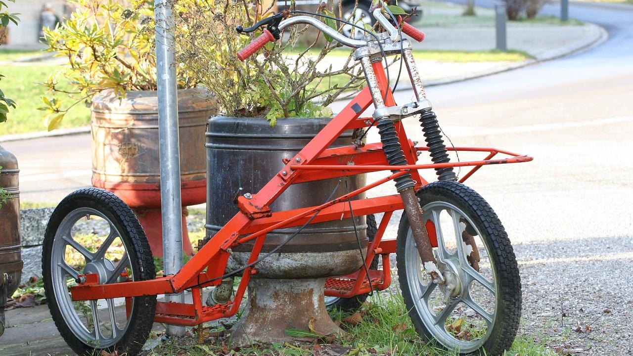red tricycle in front of pot