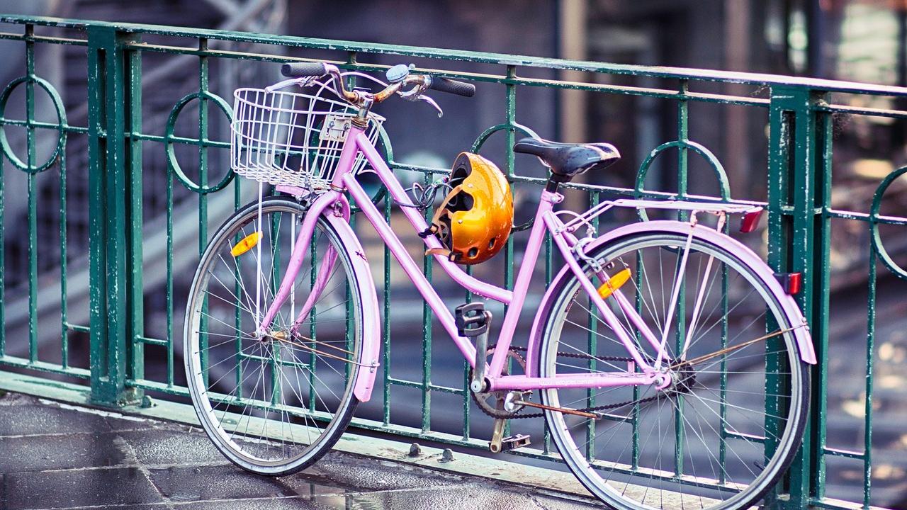 Pink bicycle in front of metal railing