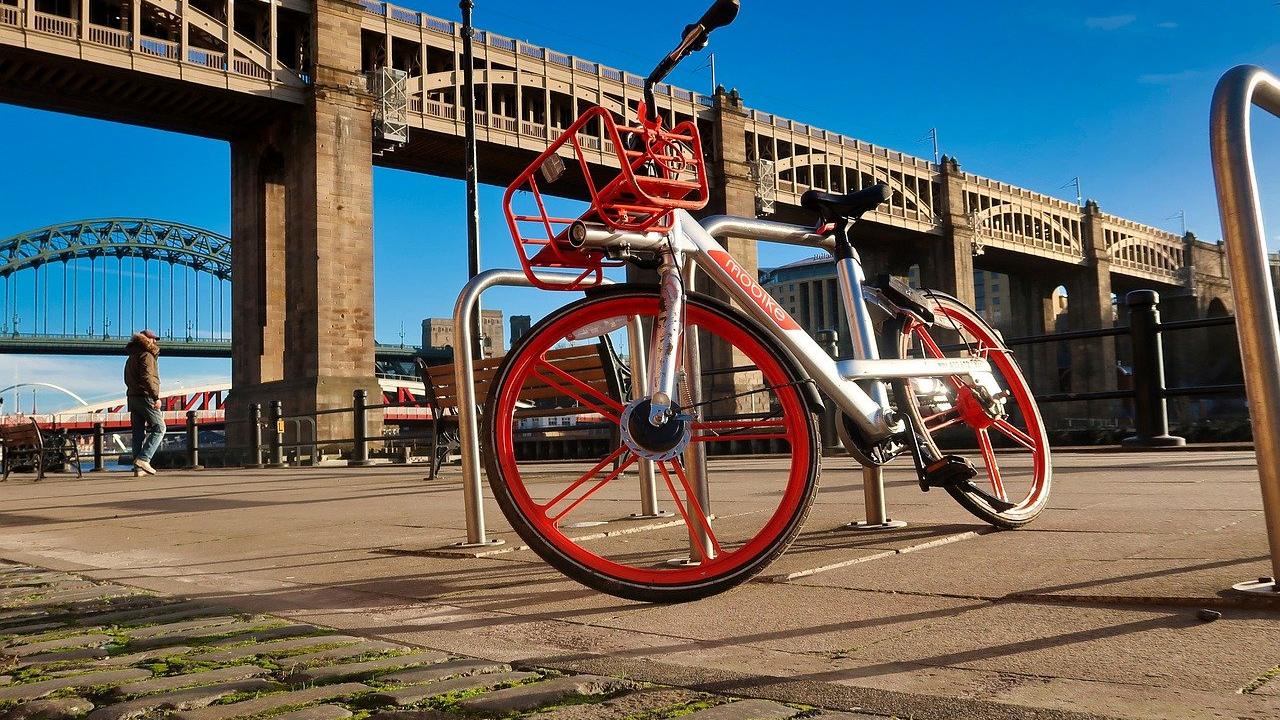 red bicycle in front of bridge