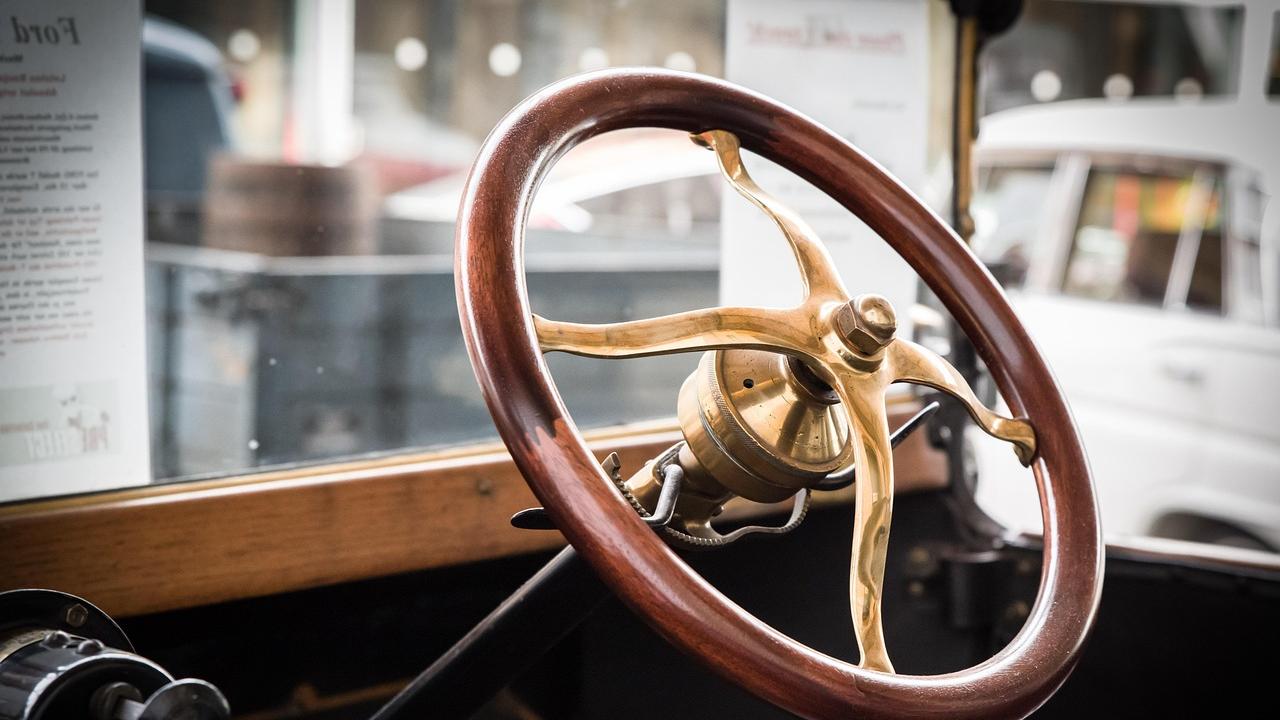 Vintage wooden steering wheel with brass center