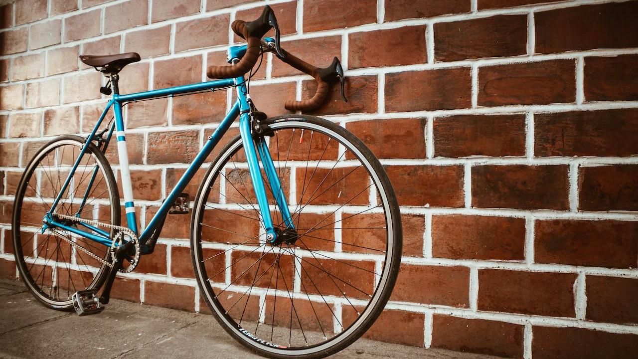Road bike leaning against brick wall