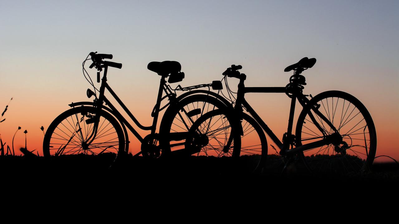 Two bicycles against a sunset