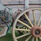wagon wheel leaning against a wagon